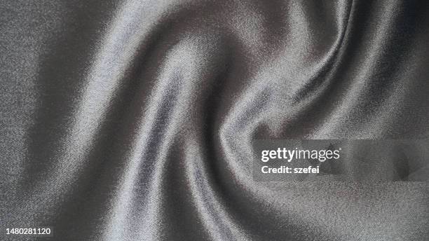 smooth elegant gray polyester textile texture fabric background. close up. - silberfarbiger hintergrund stock-fotos und bilder