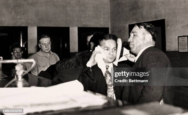 Martin 'Buggsy' Goldstein and Harry 'Pittsburgh Phil' Strauss pictured at a New York police station after surrendering themselves to District...