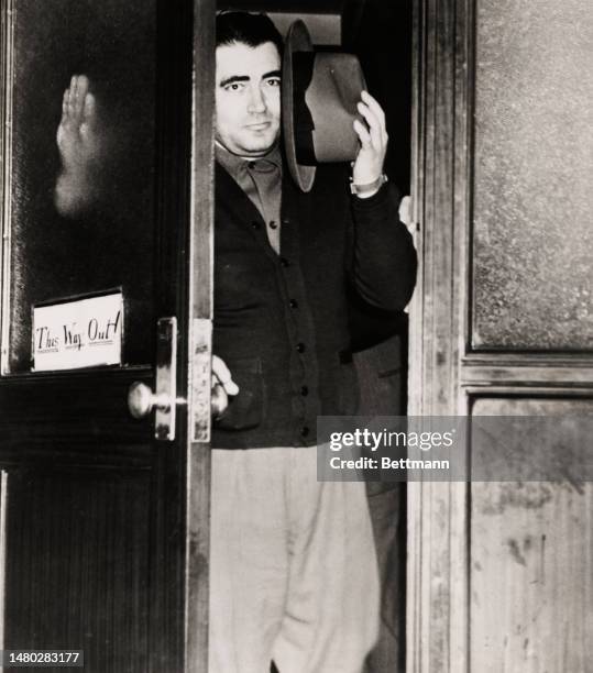 Charles 'Bug' Workman exiting the District Attorney's office in Brooklyn, New York, where he was questioned about the murder of Dutch Schultz, on...