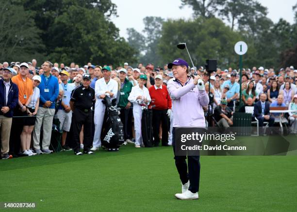 Tom Watson of The United States plays his tee shot in the Honorary Starters ceremony watched by Gary Player of South Africa and Jack Nicklaus of The...