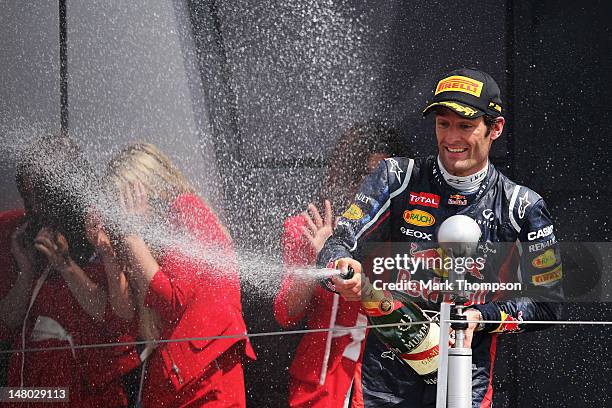 Mark Webber of Australia and Red Bull Racing celebrates on the podium after winning the British Grand Prix at Silverstone Circuit on July 8, 2012 in...