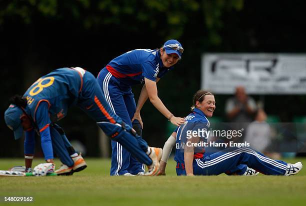 Arran Brindle of England is congratulated by Charlotte Edwards after running out Harmanpreet Kaur of India during the 4th NatWest International One...