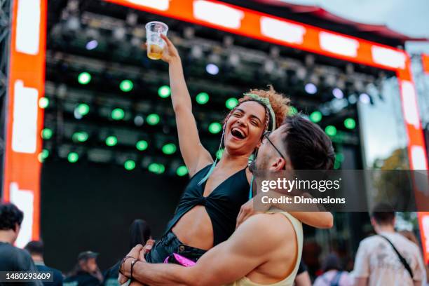 delighted couple at music festival. - livel music stock pictures, royalty-free photos & images