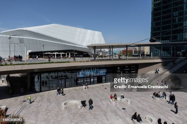 People walk and sit in the square in front of the entrance of the CityLife Shopping District on April 06, 2023 in Milan, Italy. CityLife is a...