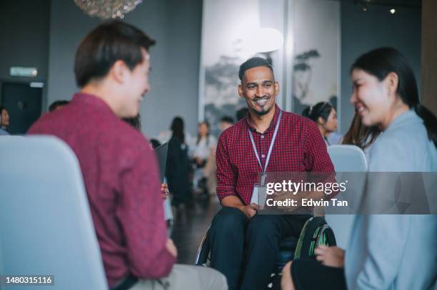 disable asian workshop participant in wheelchair in small group discussion, brainstorming during business workshop class - workshop participant stock pictures, royalty-free photos & images