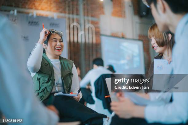joyful asian workshop participants in small group discussion, brainstorming during business workshop class - team building stock pictures, royalty-free photos & images