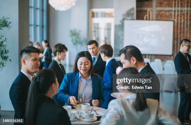 asian multiethnic business people talk during a coffee break in seminar business conference - banquet hall stockfoto's en -beelden