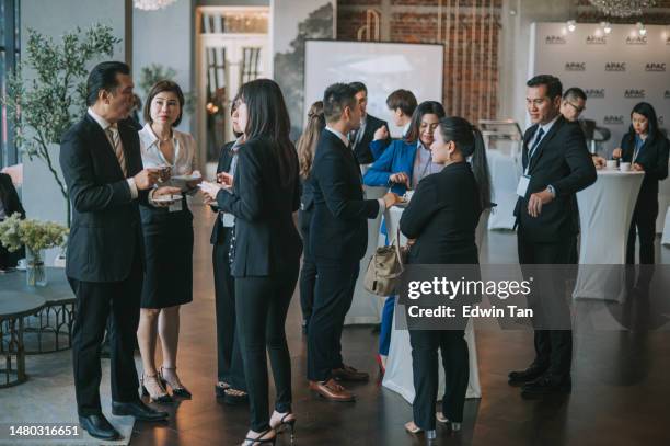 asian multiethnic business people talk during a coffee break in seminar business conference - conference hotel stock pictures, royalty-free photos & images