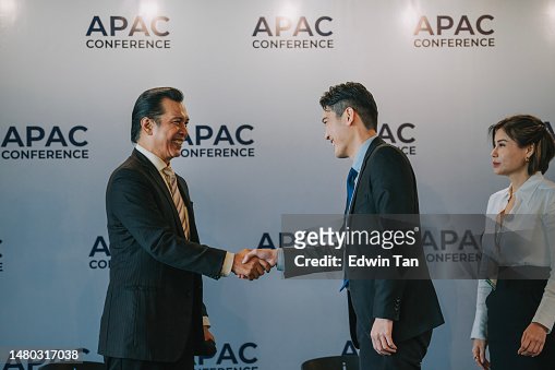Asian Business person shaking hands on stage in APAC business conference sharing session