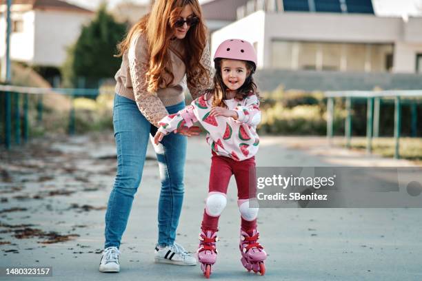 little girl rollerblading in a sunny park - inline skate bildbanksfoton och bilder