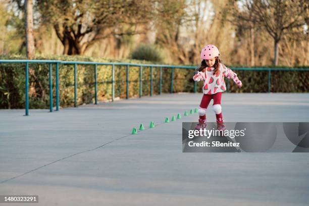 portrait smiling girl roller skating - girl roller skates stock pictures, royalty-free photos & images