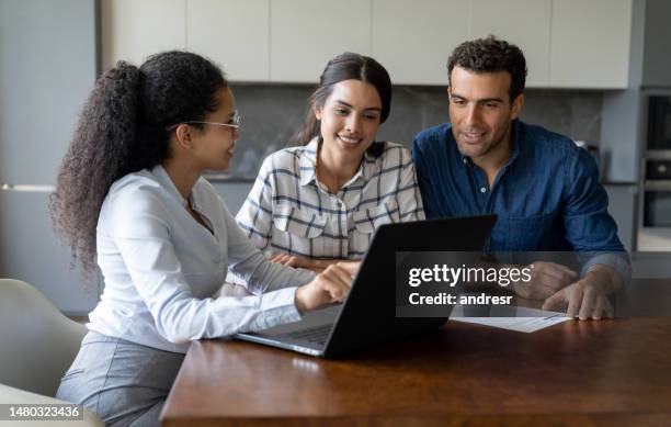 couple talking to a financial advisor about an investment - real estate agent stock pictures, royalty-free photos & images