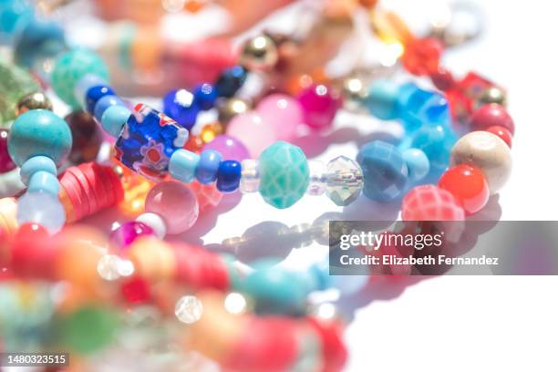 beaded jewelry on white background - chain object stock pictures, royalty-free photos & images