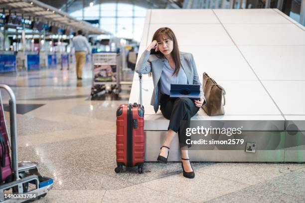 waiting for takeoff: an asian traveler's frustration with flight delays - airport frustration stock pictures, royalty-free photos & images