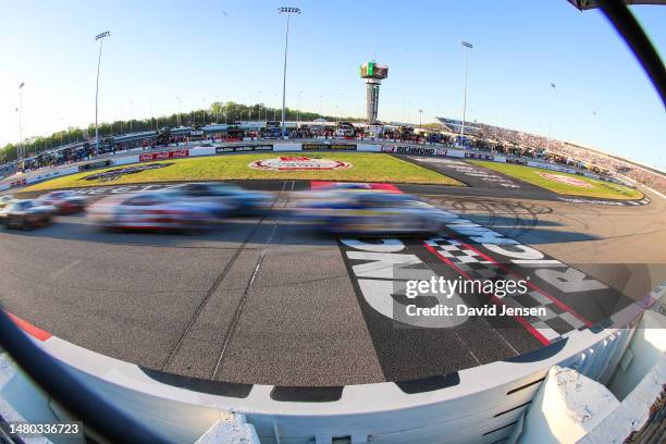 Cars cross the start line during a re-start during the NASCAR Cup Series Toyota Owners 400 at Richmond Raceway on April 02, 2023 in Richmond,...