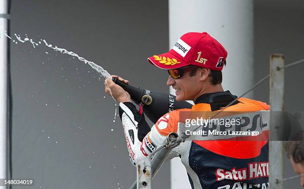 Dani Pedrosa of Spain and Repsol Honda Team celebrates on the podium the victory and sprays champagne at the end of the MotoGP race of the MotoGp of...