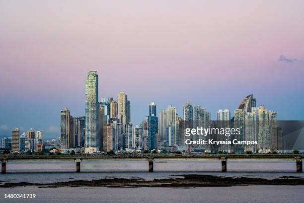 panama city skyline at sunset, seen from casco viejo - panama city fotografías e imágenes de stock