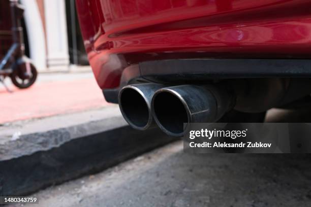 car muffler, close-up. sale of exhaust pipes or mufflers. workshop for the repair of cars and automotive equipment. retail sale of spare parts. professional car repair, service and provision of services. transport industry. - car exhaust systems stock pictures, royalty-free photos & images