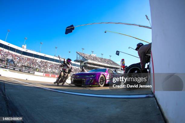 Alex Bowman, driver of the Ally Chevrolet, sits in his pit box while his crew works on his car during the NASCAR Cup Series Toyota Owners 400 at...