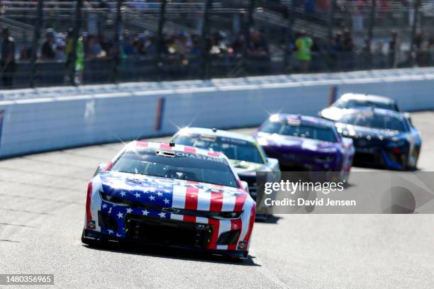 Ross Chastain, driver of the Jockey Chevrolet, leads a pack of cars down the front stretch during the NASCAR Cup Series Toyota Owners 400 at Richmond...