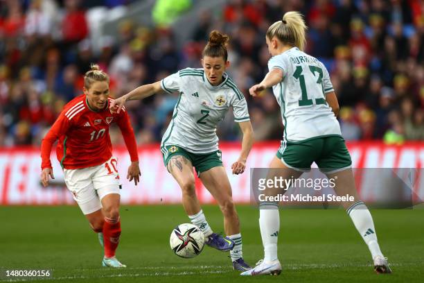 Rebecca McKenna of Northern Ireland runs with the ball whilst under pressure from Jess Fishlock of Wales during the Women's International Friendly...