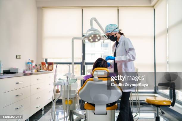 female dentist working on patient's mouth in dental clinic - dental office stock pictures, royalty-free photos & images