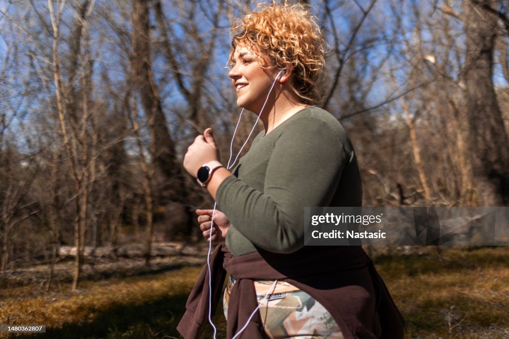 Chubby woman with curly hair running