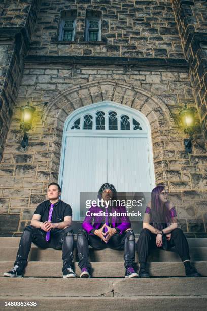 rock band trio on stairs of old castle - no church in the wild stock pictures, royalty-free photos & images
