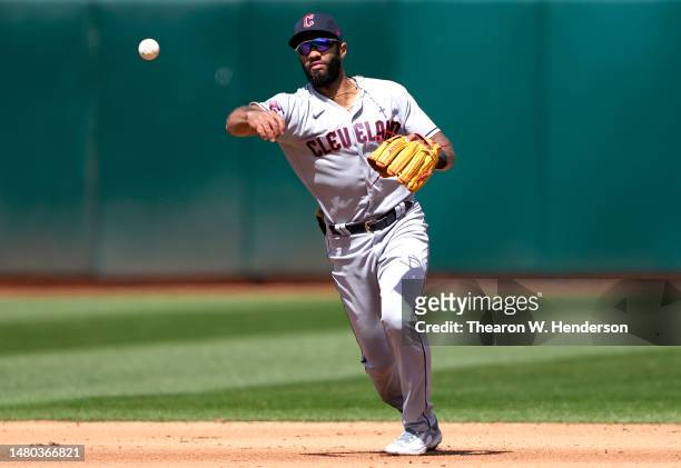 Amed Rosario of the Cleveland Guardians throws to first base throwing out Esteury Ruiz of the Oakland Athletics in the bottom of the fifth inning at...