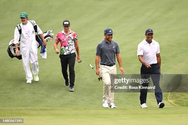 Tiger Woods of the United States, Xander Schauffele of the United States and Viktor Hovland of Norway walk on the 16th hole during the first round of...