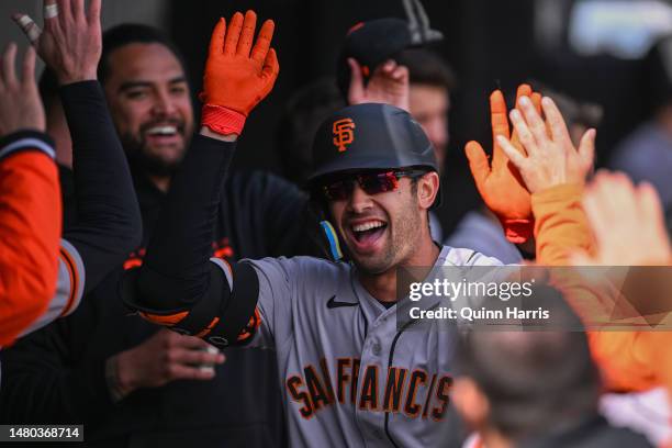 Blake Sabol of the San Francisco Giants celebrates in the dugout with teammates after his home run in the second inning against the Chicago White Sox...