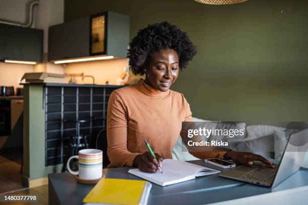young woman studying at home - workbook stock pictures, royalty-free photos & images