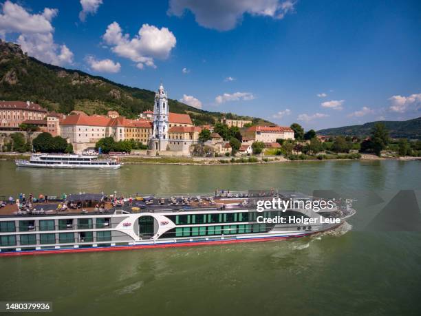 aerial of river cruise ship nickovision (nicko cruises) on danube river with dürnstein abbey (stift dürnstein) - dürnstein stock pictures, royalty-free photos & images