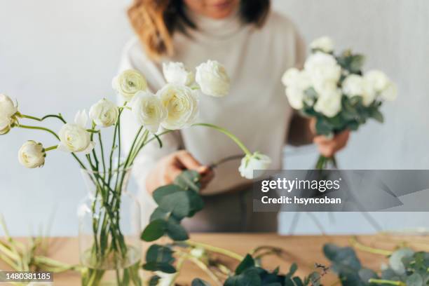 woman working in a flower shop - flower arrangement stock pictures, royalty-free photos & images