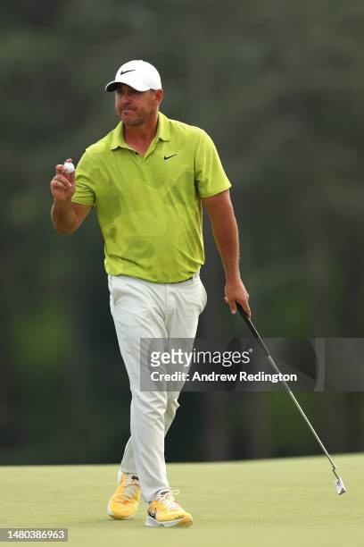 Brooks Koepka of the United States reacts to his birdie on the 18th green during the first round of the 2023 Masters Tournament at Augusta National...