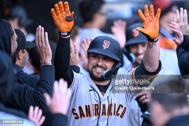 Davis of the San Francisco Giants celebrates in the dugout with teammates after his grand slam home run in the ninth inning against the Chicago White...
