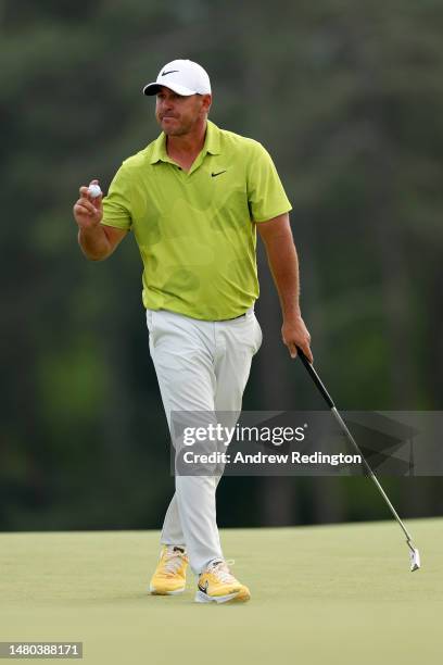 Brooks Koepka of the United States reacts to his birdie on the 18th green during the first round of the 2023 Masters Tournament at Augusta National...