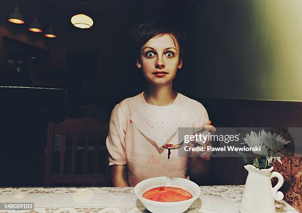 woman sitting over beetroot soup - soup on spoon imagens e fotografias de stock