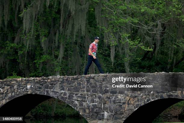 Viktor Hovland of Norway walks over the Nelson Bridge after playing his tee shot on the 13th hole during the first round of the 2023 Masters...