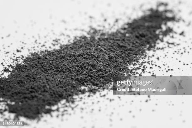 dark powder strip over white surface - gunpowder stock pictures, royalty-free photos & images