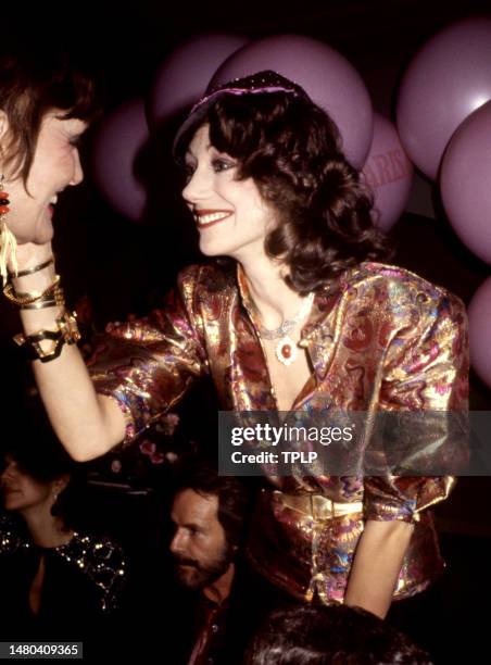 American actress and model Marisa Berenson talks to an unidentified woman at the nightclub, Studio 54 in New York, New York, circa 1977.