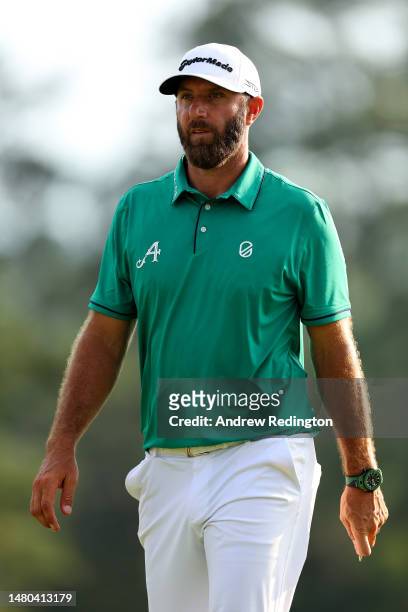 Dustin Johnson of the United States looks on from the 18th green during the first round of the 2023 Masters Tournament at Augusta National Golf Club...