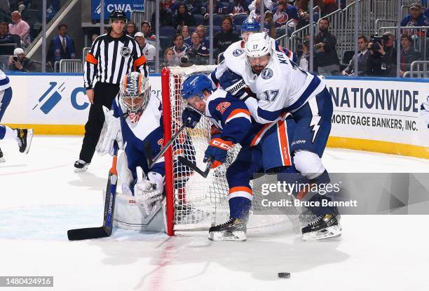 Alex Killorn of the Tampa Bay Lightning and Sebastian Aho of the New York Islanders pursue the puck during the first period at the UBS Arena on April...