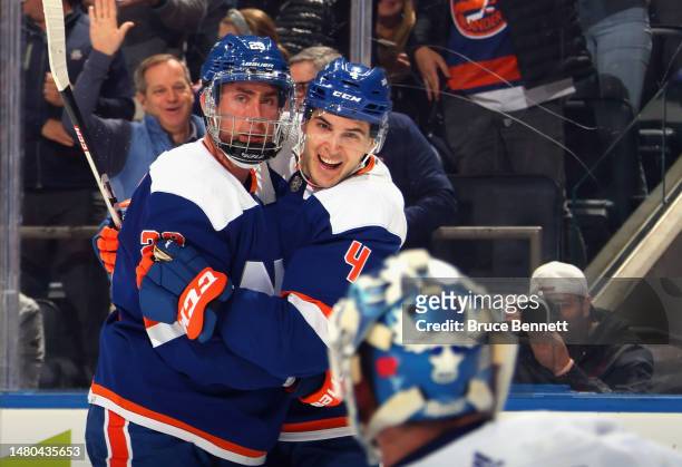 Brock Nelson is congratulated by Samuel Bolduc of the New York Islanders on his second period goal against the Tampa Bay Lightning at the UBS Arena...