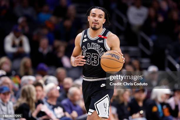 Tre Jones of the San Antonio Spurs dribbles the ball against the Phoenix Suns during the game at Footprint Center on April 04, 2023 in Phoenix,...