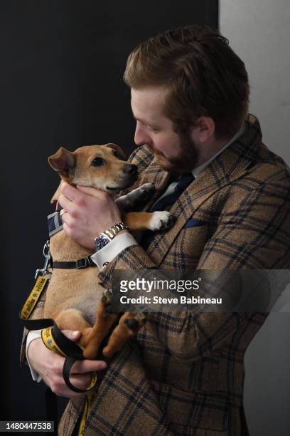 Linus Ullmark of the Boston Bruins holds a dog from the MSPCA before the game against the Toronto Maple Leafs at the TD Garden on April 6, 2023 in...