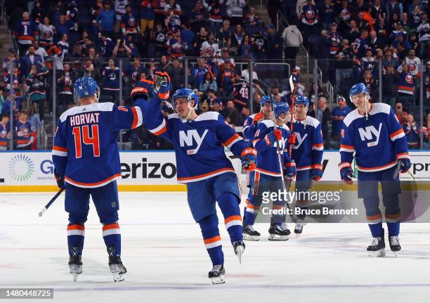 Bo Horvat and Sebastian Aho of the New York Islanders celebrate a 6-1 victory over the Tampa Bay Lightning at the UBS Arena on April 06, 2023 in...