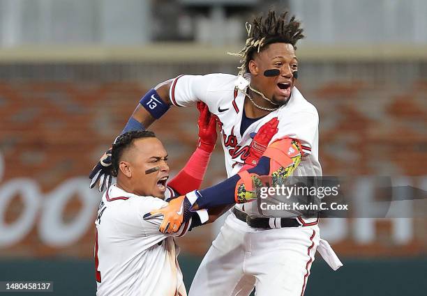 Orlando Arcia of the Atlanta Braves celebrates hitting a walk-off single in the ninth inning against the San Diego Padres with Ronald Acuna Jr. #13...