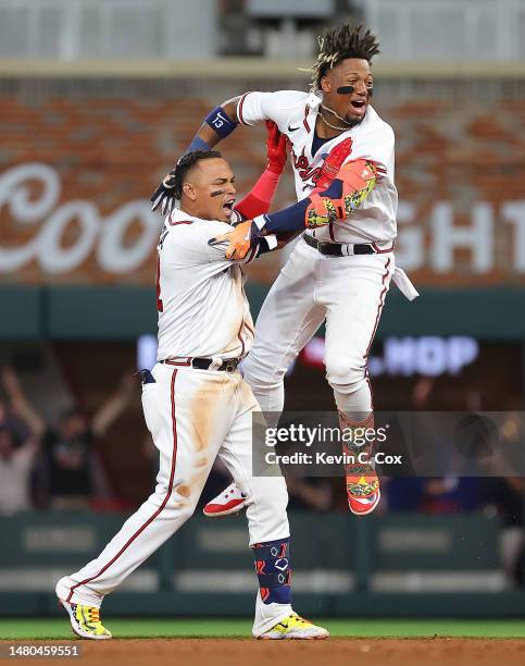 Orlando Arcia of the Atlanta Braves celebrates hitting a walk-off single in the ninth inning against the San Diego Padres with Ronald Acuna Jr. #13...