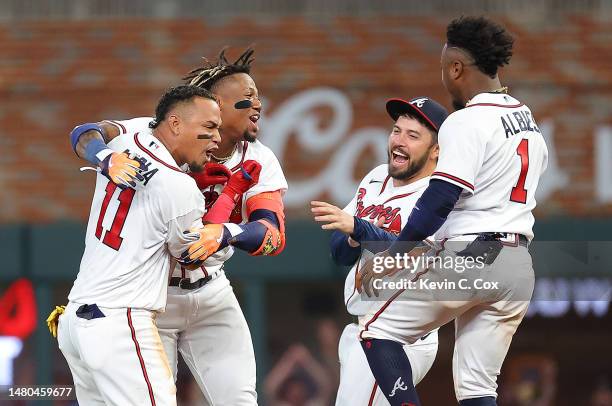 Orlando Arcia of the Atlanta Braves celebrates hitting a walk-off single in the ninth inning against the San Diego Padres with Ronald Acuna Jr. #13,...